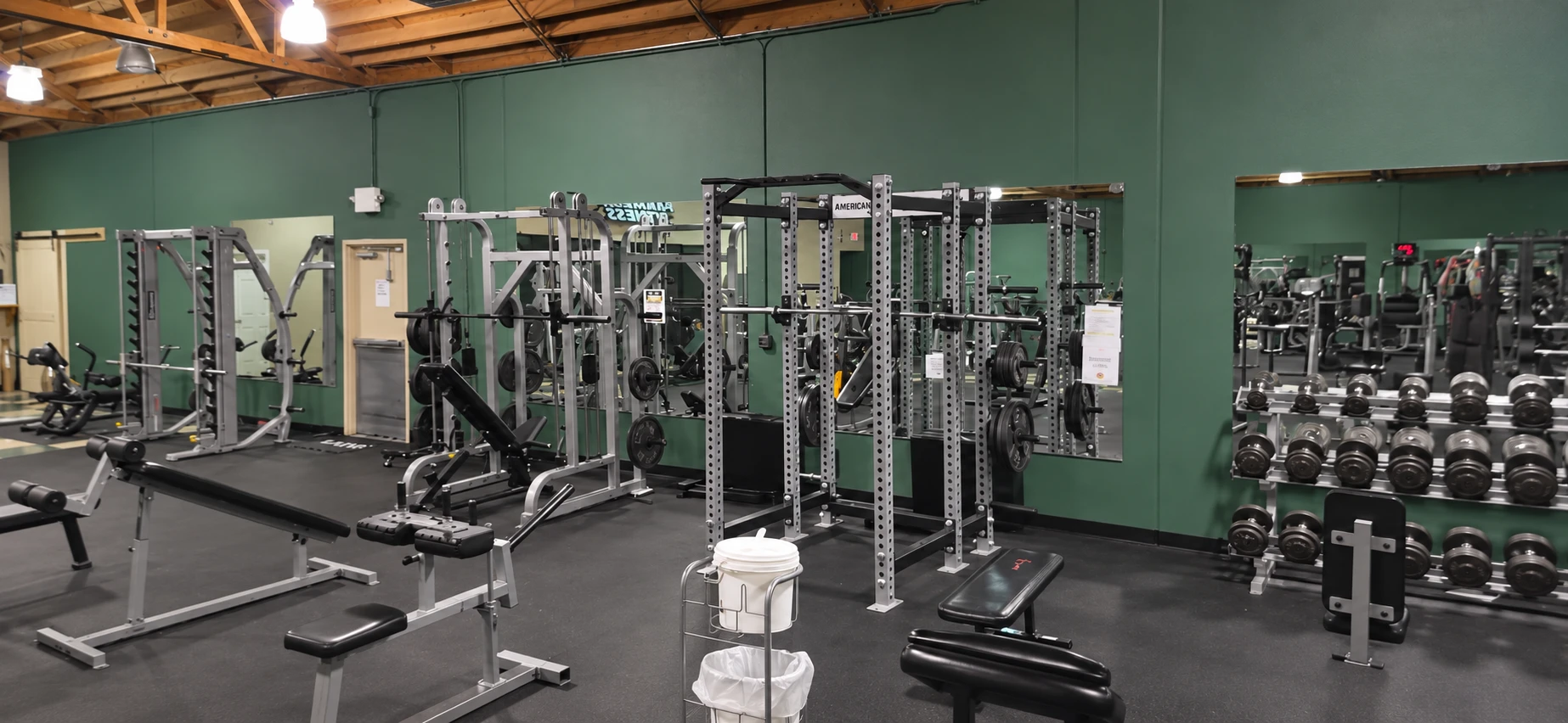 Squat racks, barbells, and benches at Paradise Fitness